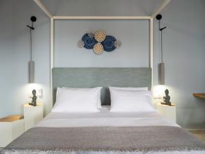 a bedroom with a large bed and a clock on the wall at Traditional House Overlooking the Libyan Sea in Kerames