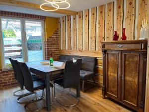 a dining room with a table and chairs at Ferienwohnung - Haus Molle in Benneckenstein