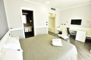 A bed or beds in a room at Palazzo Rosenthal Vesuview Hotel & Resort
