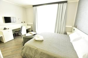 A bed or beds in a room at Palazzo Rosenthal Vesuview Hotel & Resort