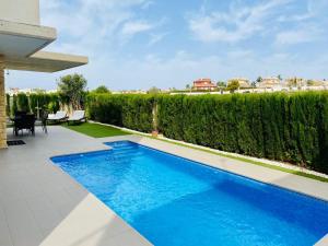 a swimming pool in the backyard of a house at Luxury villa with private pool in Rojales