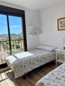 Postel nebo postele na pokoji v ubytování Precioso ático con vistas al mar y la montaña