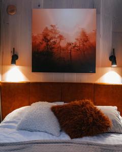 a bed with a stuffed animal on top of it at ÖÖD Hötels Laheranna SUME -with sauna in Punakivi