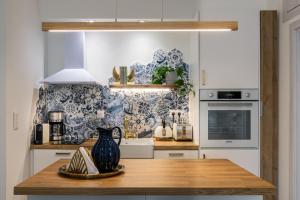a kitchen with a table with a vase on it at Chic & Comfort Homes in Central Volos # 3 in Volos