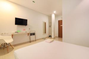 TV in/ali zabaviščno središče v nastanitvi Locus Rooms