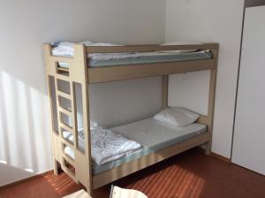 a couple of bunk beds in a room at Atelier & Herberge ViDo in Burg-Reuland