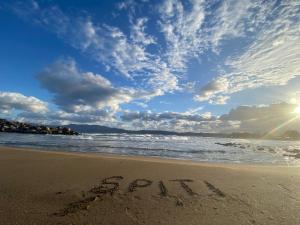 a beach with the word beach written in the sand at Spiti in Kissamos