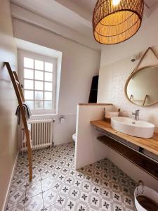 a bathroom with a sink and a mirror at NAMASTE COTTAGE in Issigeac
