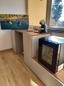 a kitchen with a fireplace and a painting on the wall at Bamboo in Procida