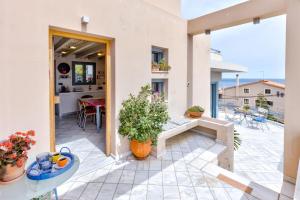 a house with a patio with a table at Monemvasia Modern Flat with Panoramic Sea View in Monemvasia