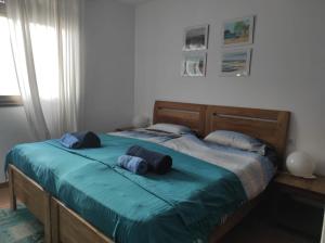 a bedroom with a bed with blue pillows on it at Laylas Beach Art House in El Cotillo