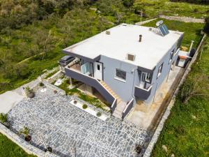 an aerial view of a blue house with a driveway at Country House Crete in Amnátos