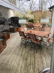 a wooden deck with a table and chairs on it at Seminar- und Urlaubshotel Schulz in Bergen