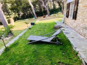 a bench sitting on the grass next to a house at Il Lampin B&B in Marina di Andora