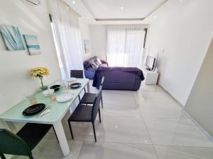 a living room with a table and a couch at Sea La Vie Seaview Apartment in Larnaka