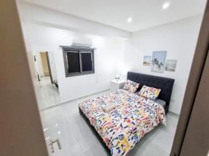 a bedroom with a bed in a white room at Sea La Vie Seaview Apartment in Larnaka +8 photos