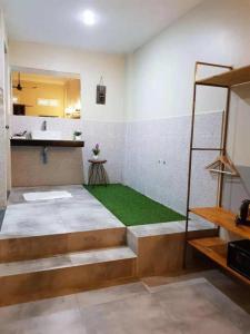 a room with a bathroom with a grass floor at Summer Bliss Boutique in Siem Reap