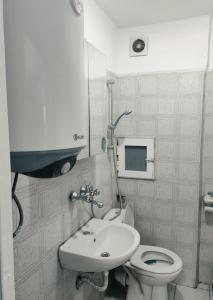 a bathroom with a toilet and a sink at Апартамент Съншайн in Burgas