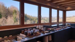 a buffet line with food in a room with windows at Landgut am Pößnitzberg in Leutschach