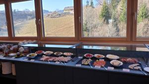 a buffet with meat and other food on a counter at Landgut am Pößnitzberg in Leutschach