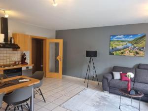 a living room with a couch and a table at Ferienweingut Arnold Fuhrmann & Sohn in Ellenz-Poltersdorf