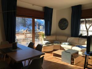 a living room with a couch and a table at Appartamento Carducci in Pieve di Cadore