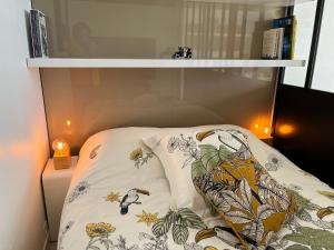 a shelf with two pillows on a bed at Malibu Beach LA BAULE appartement face à la mer ! in La Baule