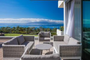 a patio with a view of the ocean at Los Jardines de Abama Suites in Guía de Isora