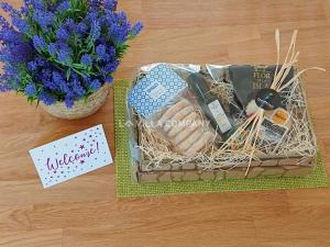 a picnic basket with a bouquet of flowers and a note at Villa Isabel in Cala En Porter in Cala en Porter