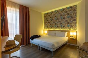 Ένα ή περισσότερα κρεβάτια σε δωμάτιο στο Hotel Ambra
