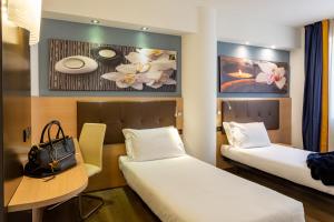 Ένα ή περισσότερα κρεβάτια σε δωμάτιο στο Hotel Ambra