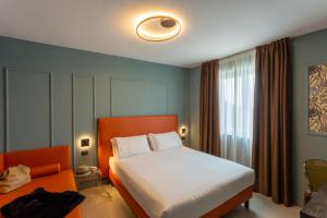 Ένα ή περισσότερα κρεβάτια σε δωμάτιο στο Hotel Ambra