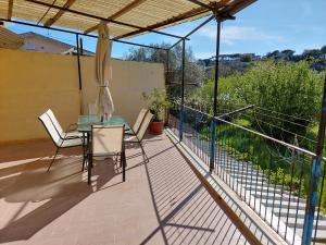 a patio with a table and chairs on a balcony at Casa Gargiulo in Massa Lubrense
