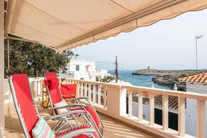 a balcony with chairs and a view of the water at Caseta Diana - Alcaufar in Sant Lluis