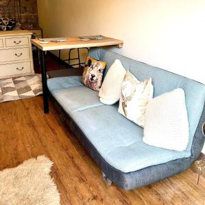 a blue couch with pillows on it in a living room at Woolston lodge in Oswestry