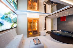 a bathroom with a soaking tub and a large window at Parkside Apartments Old Town in Kraków