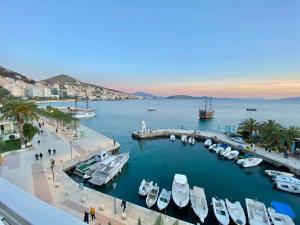 a group of boats docked in a harbor at Sun N Blue Hotel in Sarandë
