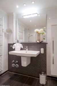 a bathroom with a sink and a mirror at Vik6 9 Viktoria Residenz in Westerland (Sylt) +4 photos