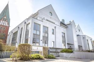 a white building with a sign on the side of it at Vik6 9 Viktoria Residenz in Westerland (Sylt)