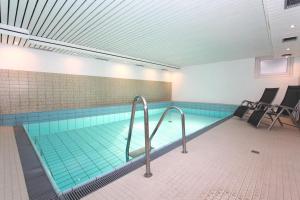 a large swimming pool in a building with at Big Wave _Vik1 _ 24_ in Westerland