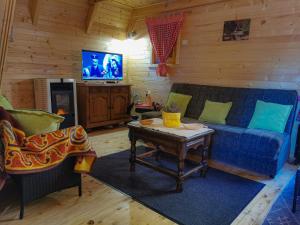 a living room with a blue couch and a table at Breeze Home Cottage in Cetinje