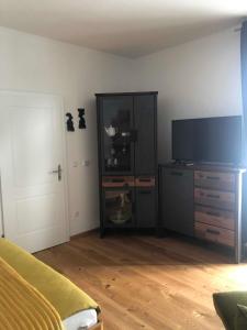 a bedroom with a tv and a dresser with a dresser at Zum Radwerk TOP 11 in Vordernberg