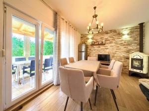 a dining room with a table and chairs and a fireplace at Apartment Ankica in Polje