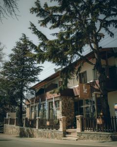 a building with a tree in front of it at Kallithea INN in Platres