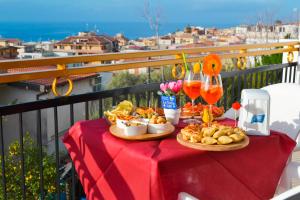 a table with food and drinks on a balcony at Le Twins -Bed and Breakfast in Tropea