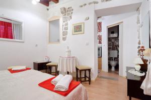 a bedroom with a bed and a table with towels at Apartment City Center Dragica in Zadar