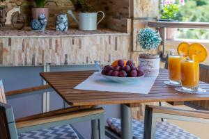 a table with a bowl of fruit and orange juice at Penthouse Apartment Marija in Cavtat