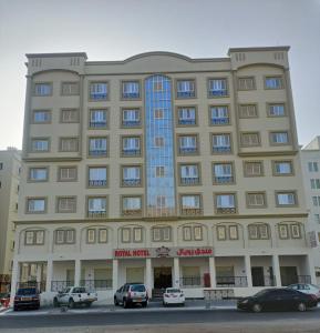 a large building with cars parked in front of it at ROYAL HOTEL in Muscat