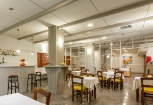 a dining room with tables and chairs in a restaurant at Asterion Hotel in Heraklio