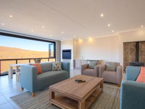 a living room with a couch and chairs and a table at Highland Gate Ferox Creek in Dullstroom